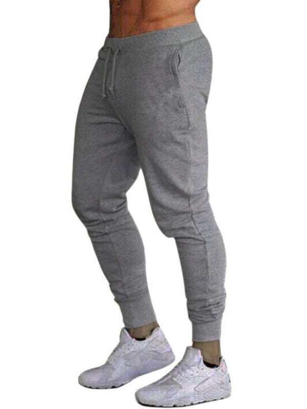 Men's solid color loose elastic sweatpants, mid waist, gray fabric, ideal for sports and casual wear.