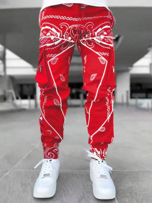 Red cashew flower printed men's harem pants with multi-pocket design.