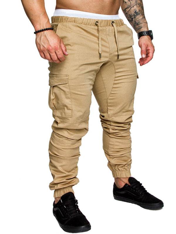 Men's solid color casual tether elastic sports baggies trousers, polyester-cotton, flap pockets.