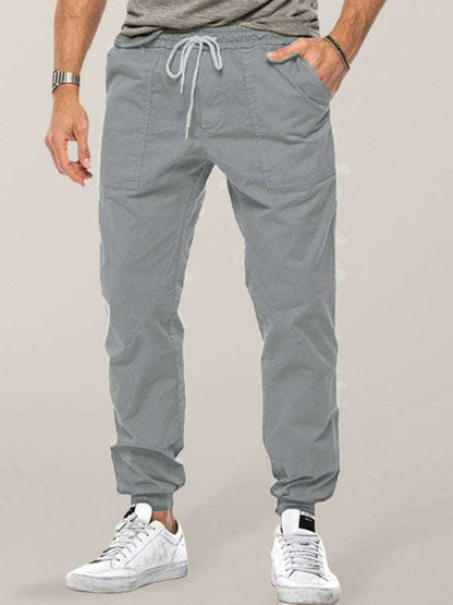 Men's casual pants with trendy loose fit and slant pockets, made of cotton and polyester blend.