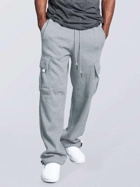 Men's grey loose fit cargo pants with elastic waist and multiple pockets.