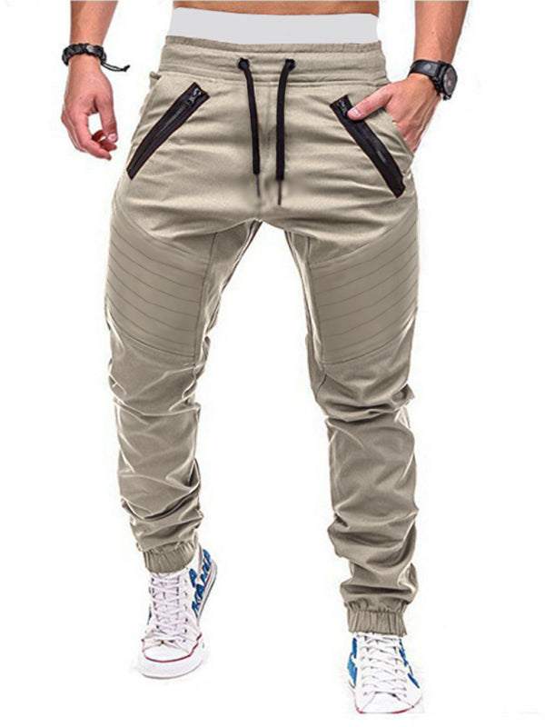 Men's contrasting color zipped loose-fitting casual pants with slant pockets and elastic waistband, ideal for street style.