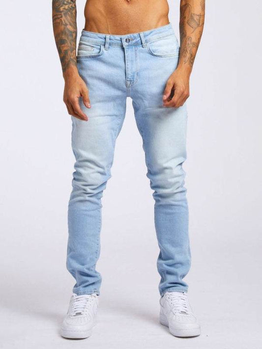 Men's solid slim fit basic skinny jeans in light blue, featuring a mid-waist design and welt pockets.