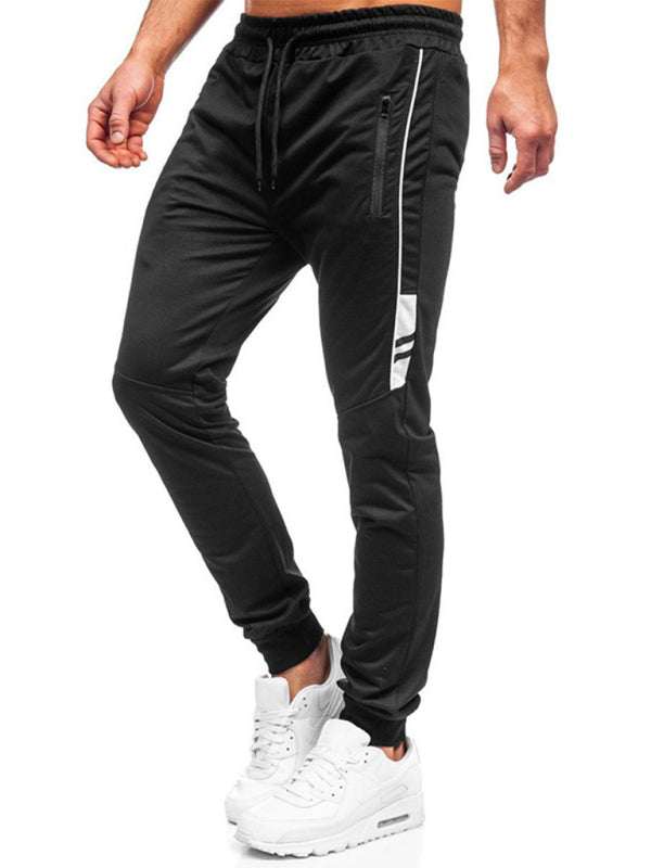 Men's black casual fashion sports trousers with white accents, elastic waist, and slant pockets.