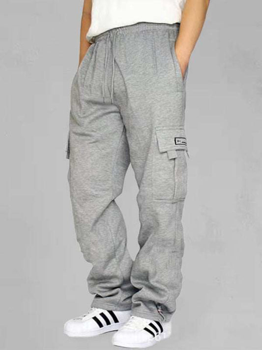 Loose fit gray men's sports cargo trousers with flap pockets and elastic waist.