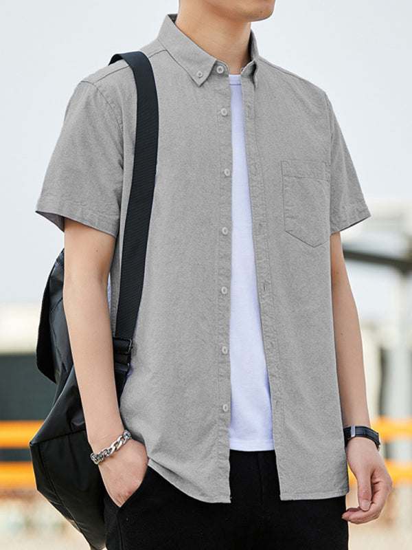 Casual Oxford short-sleeved shirt with double pockets, youthful fashion style, worn by a person.