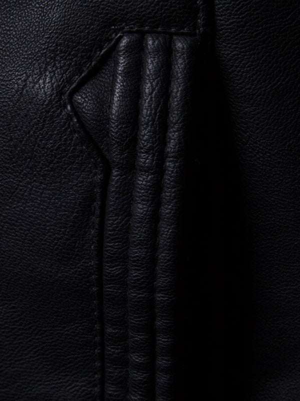 Close-up of black leather texture on men's motorcycle zipper stand collar jacket.