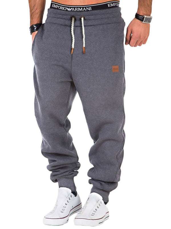 Men's gray elastic waist sports casual trousers with drawstring and slant pockets.