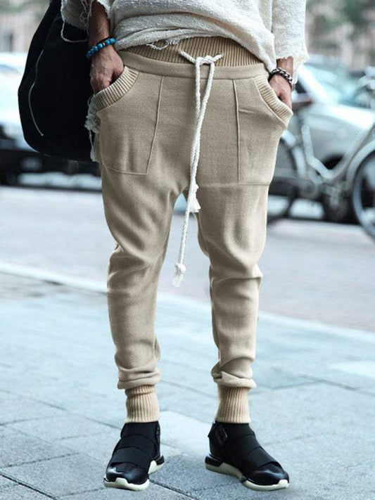 Men's casual loose leg color block knitted trousers with drawstring.