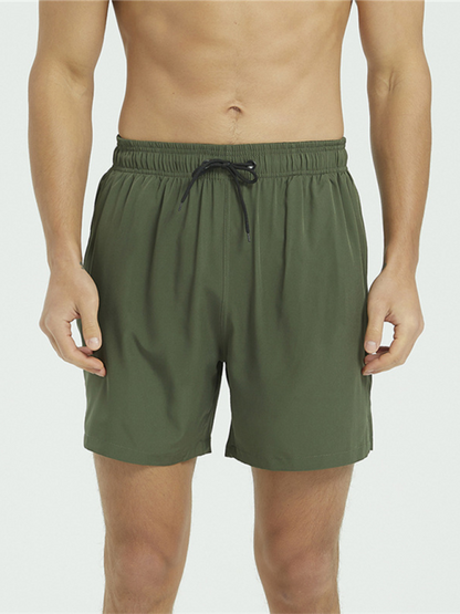 Men's green fitness quick-drying stretch beach pants with drawstring and elastic waistband.